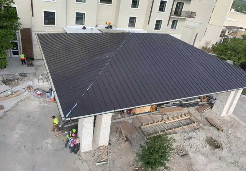 Metal roofing installation team working on a commercial building in Mount Arlington